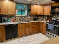 Large country kitchen with plenty of cabinets and countertops.