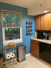 Window in kitchen overlooks driveway.