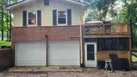 New insulated garage doors lead to basement garage.