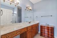 Primary bath with wall to wall vanity, large mirrors and lighting
