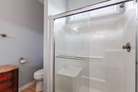 Oversize walk in shower with seat and grab bar for comfort and safety.