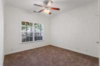 Front bedroom with views of the rear of the home and screened in porch.  Large step in closet.