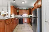 Kitchen area includes a plethora of cabinetry, under cabinet lighting and a peninsula for eating/serving guests.