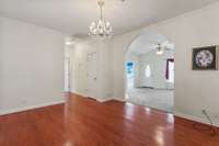Gleaming hardwood floors in the dining area with arch door way from Living area.