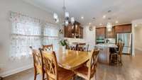 Upgraded kitchen featuring a gas stove with vented hood, built-in microwave and oven, large pantry, and an graded island perfect for meal prep and entertaining.