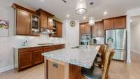 Upgraded kitchen featuring a gas stove with vented hood, built-in microwave and oven, large pantry, and an graded island perfect for meal prep and entertaining.
