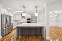 New Stainless Refrigerator, Dishwasher and Cabinet Island with Sitting Area at Bar.