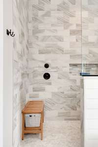 Notice the thoughtful placement of the water turn-on at the entry of the spacious shower.  There is room to sit and wait for your desired temperature without having to brave any cold water at the other end.