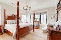 Did I mention that peaceful nature views are to be found in just about every room of this home?  This primary suite with FIVE windows gives ample peaceful viewing opportunities! (How many suites have you seen with five windows?)