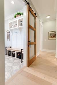 There is yet another solid wood and glass door seen from the garage entry to enhance the beauty of this home!