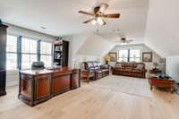 At 30 feet by 18 feet, this room easily houses multiple uses, as shown here with both an office and another full living space.  And this is yet another room with five windows, so ample light abounds!