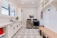 This laundry/drop zone/craft room is to die for!!  Beautiful tile flooring, ample cabinet space, hanging area, and a place to sit as you come in the back door.  What would you use this room for, other than laundry?