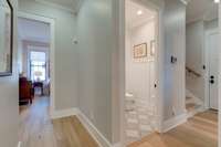 The back hall on the north side of the home leads to two more guest rooms and another full bath, and a beautiful powder room for those guests not staying overnight.