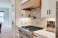 Top of the line Thermador gas range, pot filler, beautiful custom backsplash and range hood will make anyone look like a great cook!