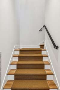 The stairs are accented with a beautiful runner