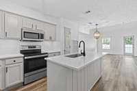 Beautiful kitchen with quartz countertops and updated appliances