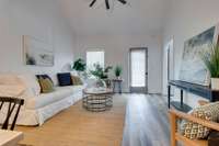 Large living room space with access to fenced patio