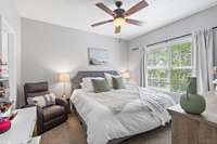 Large primary bedroom with large windows