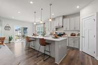 This home features tens of thousands in kitchen upgrades an extended kitchen island, wood-look LVP flooring, quartz countertops, upgraded cabinets, upgraded lighting, upgraded backsplash and stainless steel appliances!