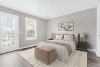 Spacious primary bedroom suite has abundant natural light, access to the balcony, a walk in closet and a newly remodeled bathroom. Room is virtually staged.