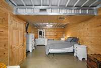 Another view of basement primary bedroom. Finished concrete floors are a breeze to clean and look great!
