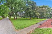 Long driveway with shade trees canopying over drive is a DREAM!