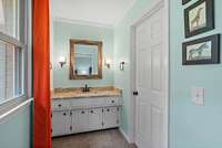 Primary bathroom sink/vanity area is separate from shower and toilet.