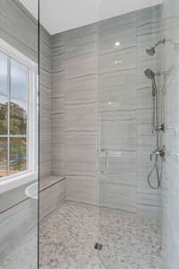 Fully tiled showers each with built out seats/benches