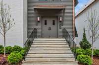 Grand limestone entrance with an abundance of copper details.