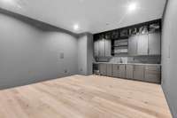 Lower level theatre room with full wet bar, refrigerator drawers, and projector and theatre equipment included.