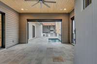 No expense was spared with this outdoor courtyard. The motarized screen allows for a fully screen porch that leads into the pool/spa and outdoor kitchen area.