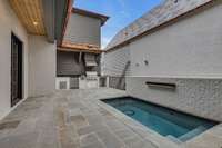 Pool and spa with fountain and outdoor kitchen with Wolf range and beverage/wet bar.