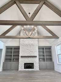 A centerpiece fireplace, flanked by built-in bookcases, adds warmth & character to the space, making it the perfect spot for cozy evenings with loved ones.