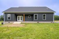 Back of home with covered porch