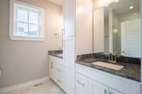 Gorgeous bathroom attached to primary bedroom complete with double vanities and custom cabinets!