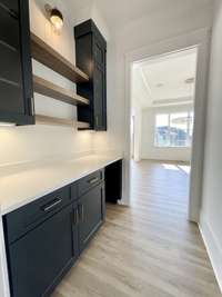 The butler pantry provides a great space for mixing cocktails for a soirée or plating hors d'oeuvres for a gathering of friends, and offers a versatile workspace that adapts to your every need. TO BE BUILT - CONSTRUCTION HAS NOT STARTED