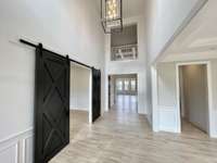 Approaching this exquisite home, the classic architecture and impeccable details provide an immediate sense of grandeur. A stately entrance with finely crafted doors hints at the luxury that awaits within. TO BE BUILT - CONSTRUCTION HAS NOT STARTED