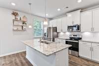 Granite counters and bright kitchen