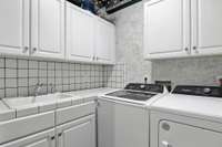 This functional laundry space offers everything you need, including a sink, all just steps from the main living areas.