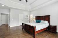 The walk-in closet features custom wood shelving and plenty of space to keep everything organized and at your fingertips.  The french doors lead to the primary bathroom.