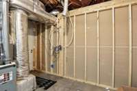 This attached work room features a concrete floor with a drain and a utility shower - perfect for dog washing, gardening cleanup, or messy projects.