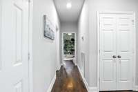 A central hallway leads to the spacious primary suite and two additional bedrooms.