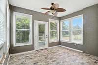 With an exposed brick wall, brick tile floors, and windows on three sides, this sunroom is full of charm and sunshine.