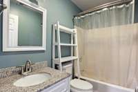 Flex room #2 full bathroom with granite-topped vanity, and tub/shower combo.