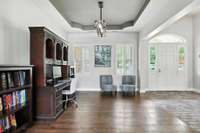The formal dining room (currently used as an office) is a lovely space to welcome your guests