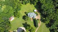 Room to breath, grow, and gather.  This stunning aerial view captures the quiet luxury of life on >3 acres