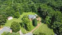 Tree-lined drive, timeless charm - this serene escape is ready to welcome you home!