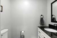 Tucked just around the corner from the dining room, this powder room is perfectly placed for guest use.