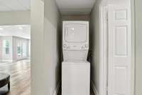 Stacked washer/dryer remain with the apartment and are conveniently placed at the end of the hallway.
