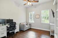 Enjoy a front-facing view and a generously sized closet with custom shelving in this bright, inviting bedroom.